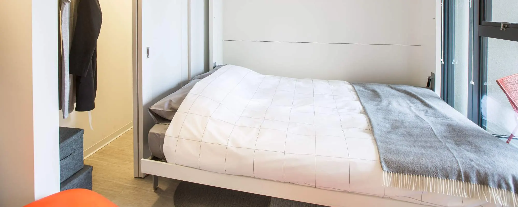 Bed and closet at Exhibit On Superior in Chicago, Illinois